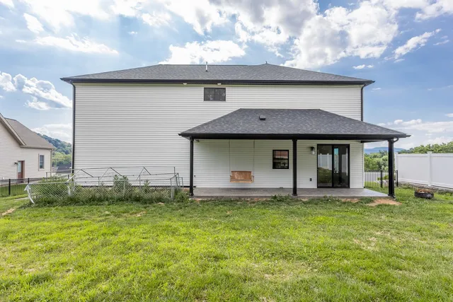 a backyard of a house with lots of green space and fountain