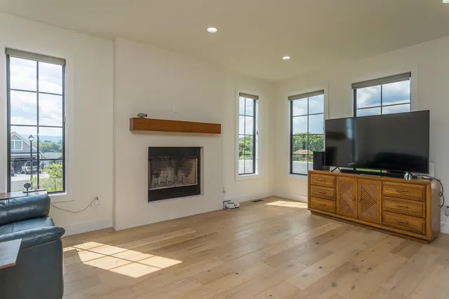 a kitchen with white cabinets and a window