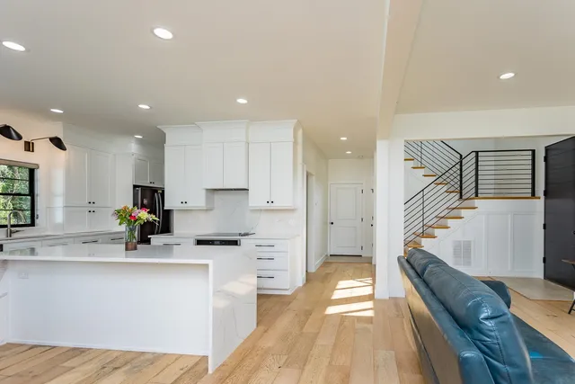 a view of kitchen with a refrigerator cabinets and a ceiling fan