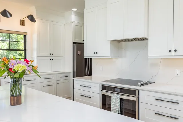 a large kitchen with a table and chairs