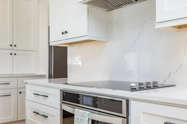 a large kitchen with a table and chairs
