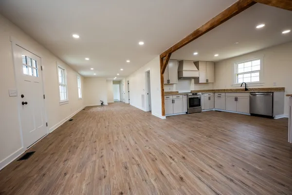 a large kitchen with stainless steel appliances granite countertop a large center island and a sink