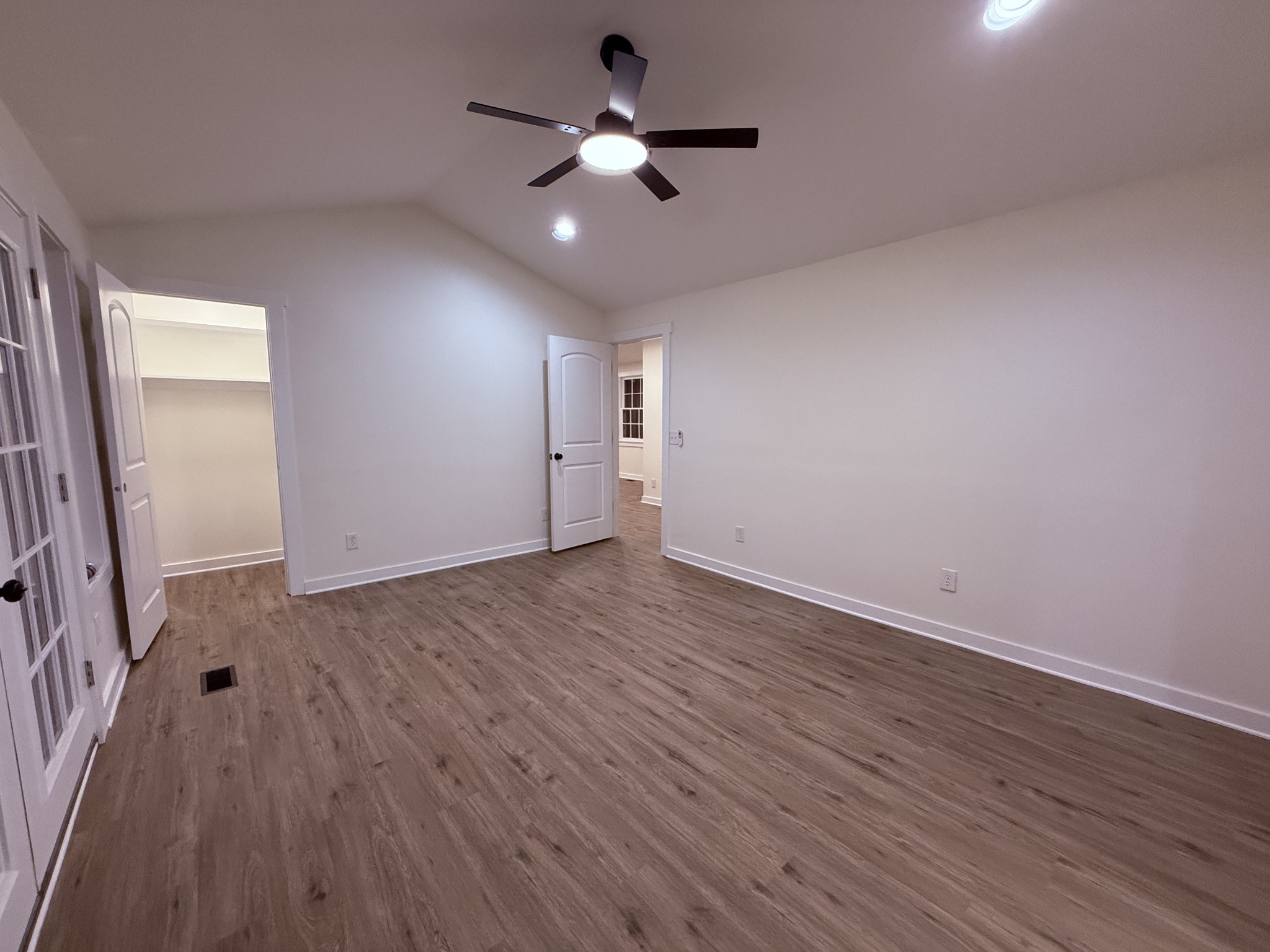 622 Beech Street Centerville, TN 37033 - Photo 14 of 30 an empty room with wooden floor chandelier fan and windows