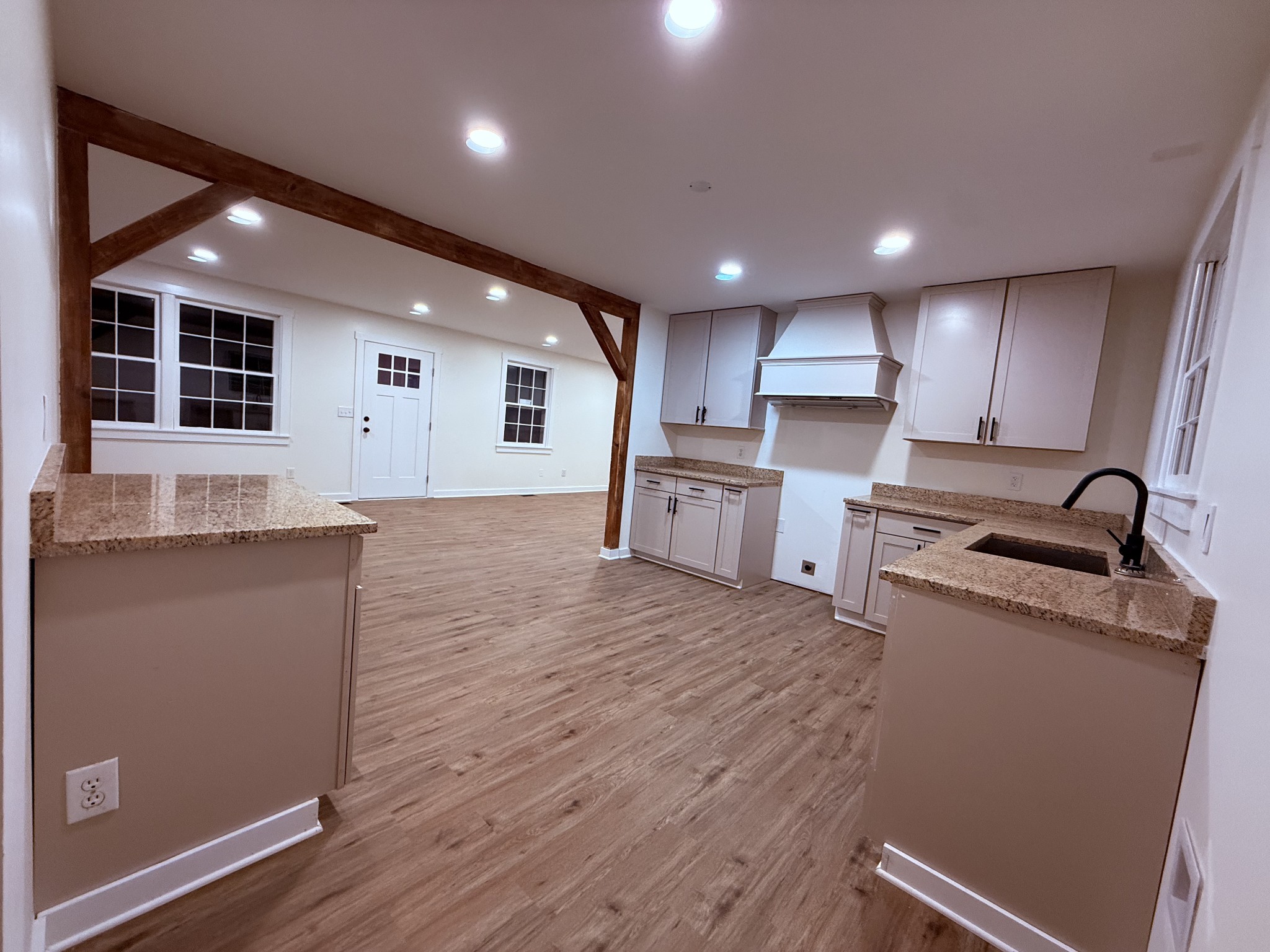 622 Beech Street Centerville, TN 37033 - Photo 2 of 30 a kitchen with stainless steel appliances granite countertop a refrigerator a sink dishwasher a stove and white countertops with wooden floor