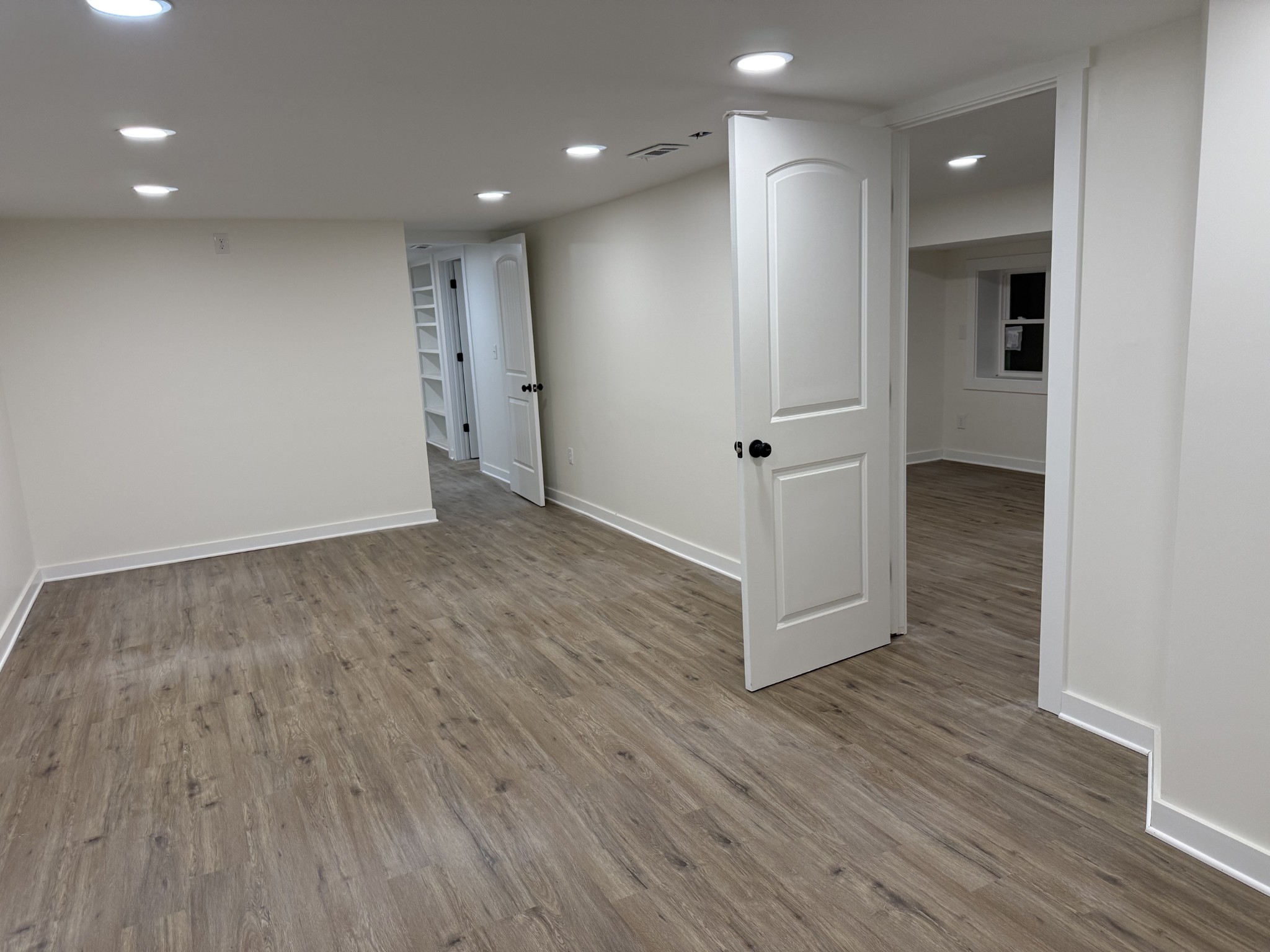 622 Beech Street Centerville, TN 37033 - Photo 21 of 30 an empty room with wooden floor and windows