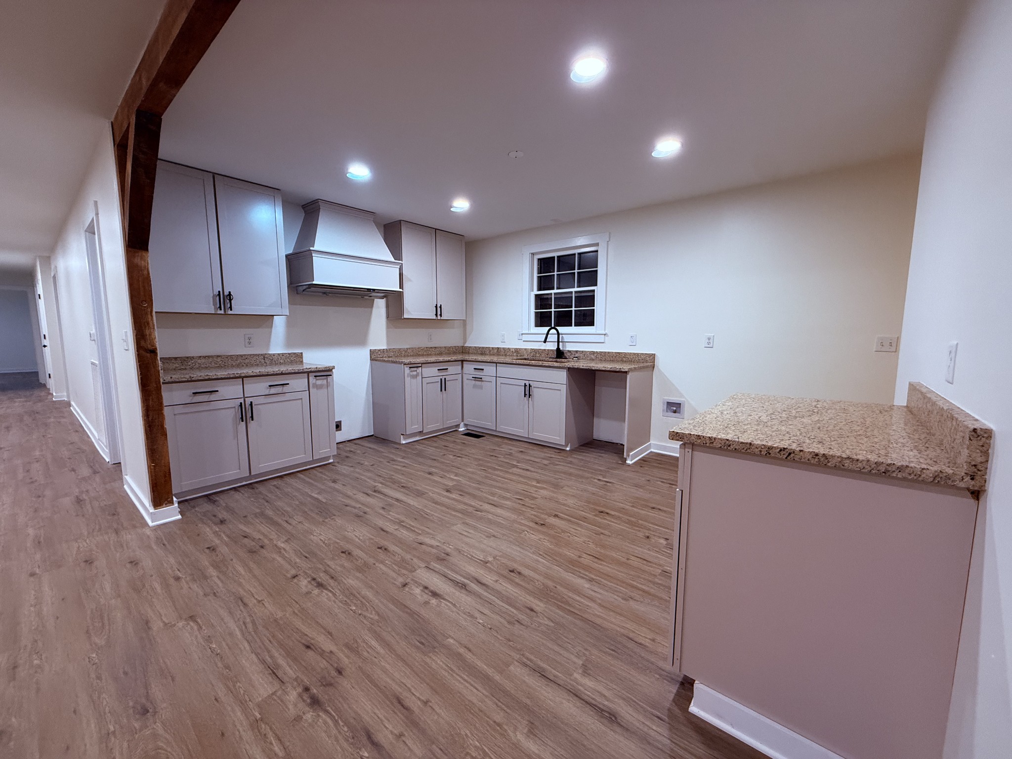 622 Beech Street Centerville, TN 37033 - Photo 3 of 30 a large kitchen with a center island wooden floor and stainless steel appliances