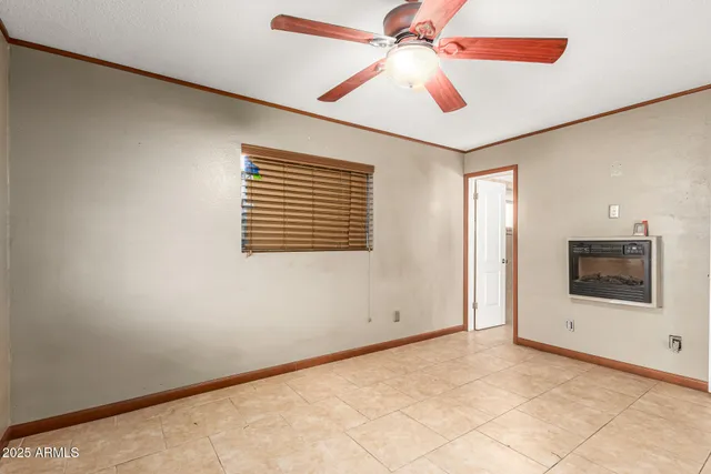 a view of a room with a ceiling fan and a window