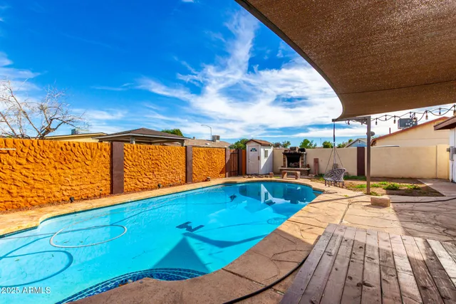 a view of swimming pool with seating area