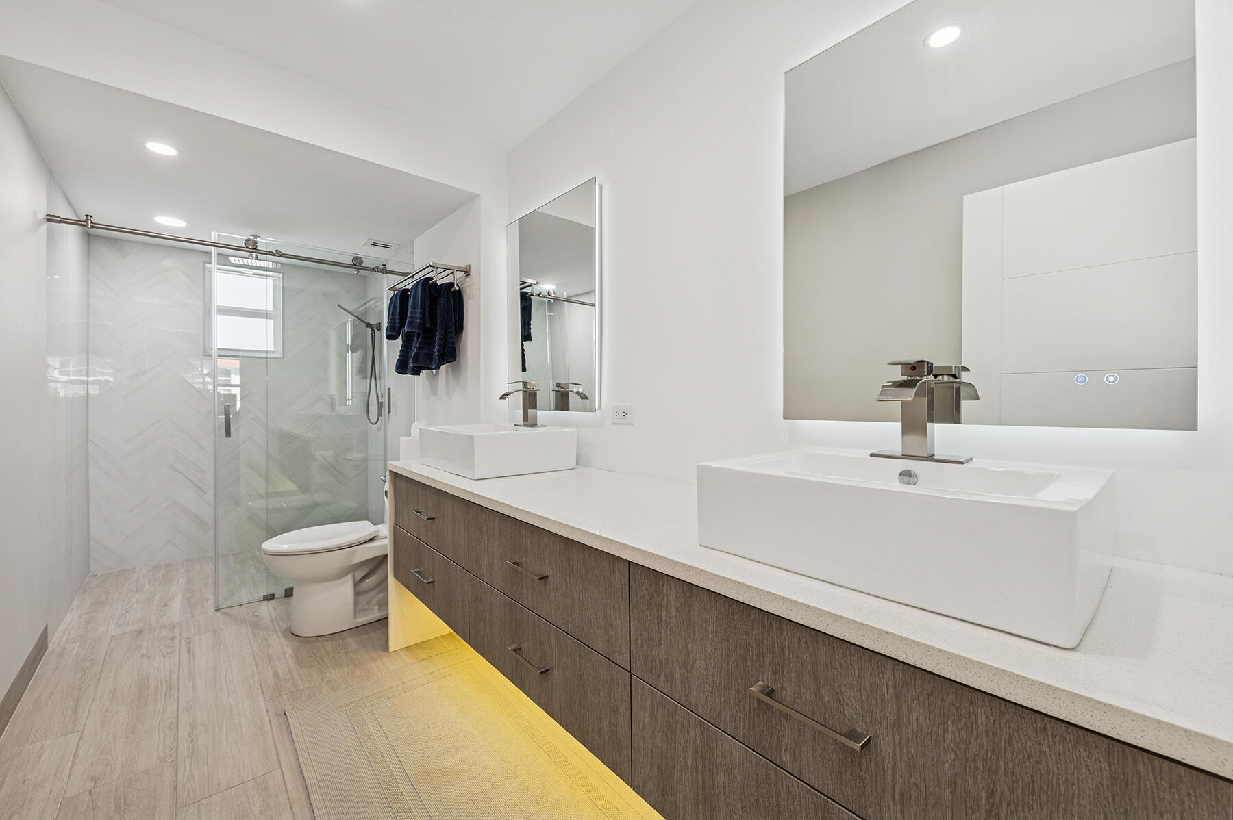 2871 North Ocean Boulevard, Unit M436 Boca Raton, FL 33431 - Photo 13 of 20 a bathroom with a toilet sink a mirror and shower