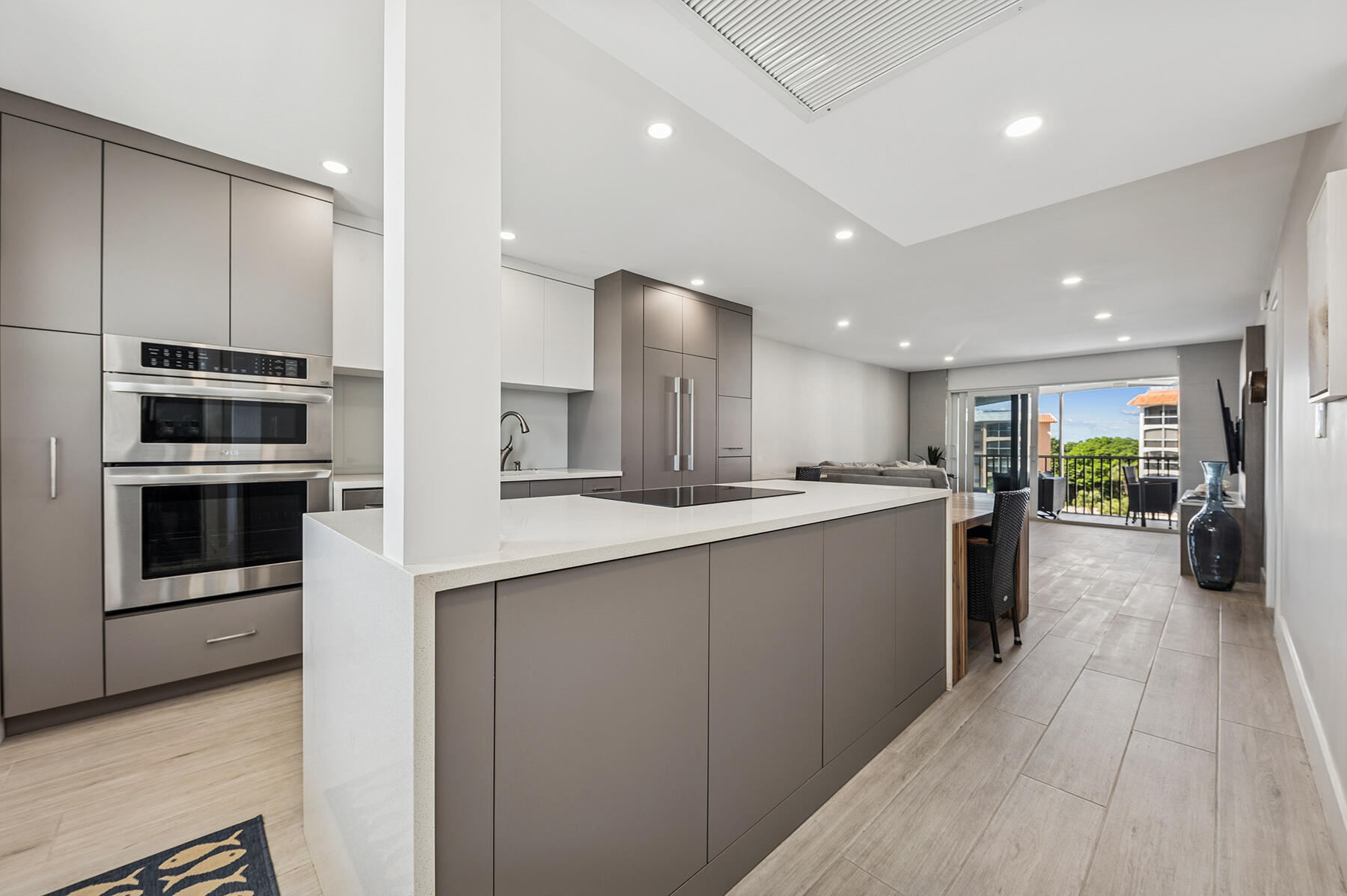 2871 North Ocean Boulevard, Unit M436 Boca Raton, FL 33431 - Photo 5 of 20 a large kitchen with a large counter top stainless steel appliances and cabinets