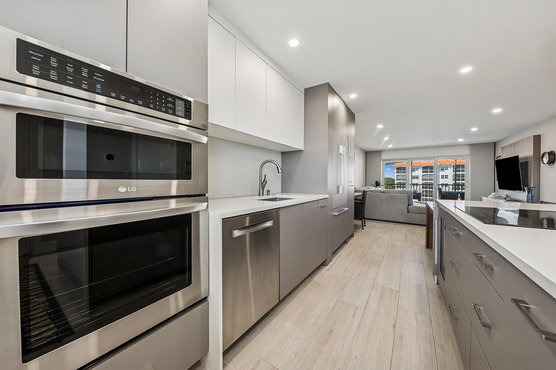 2871 North Ocean Boulevard, Unit M436 Boca Raton, FL 33431 - Photo 6 of 20 a kitchen with stainless steel appliances kitchen island a stove and a microwave