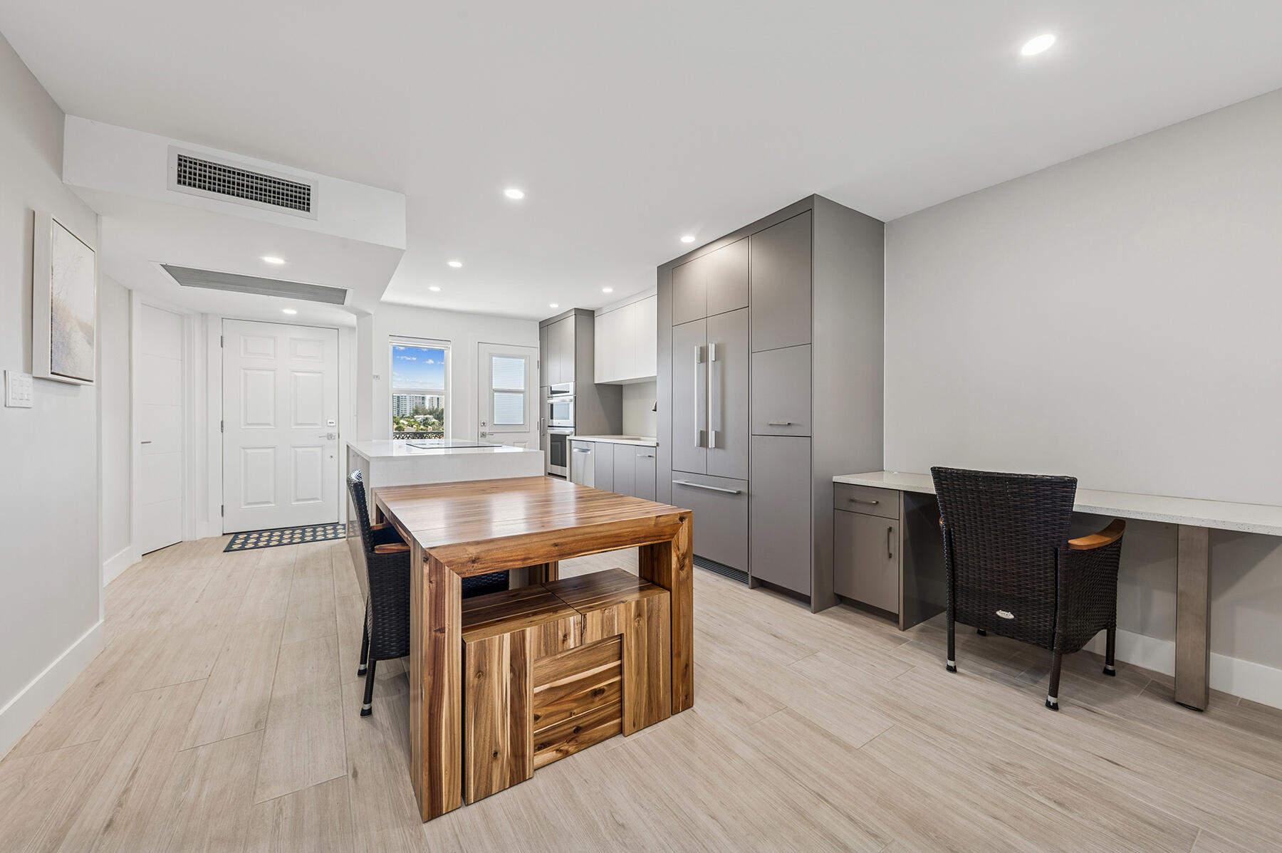 2871 North Ocean Boulevard, Unit M436 Boca Raton, FL 33431 - Photo 8 of 20 a kitchen with stainless steel appliances granite countertop a refrigerator a sink dishwasher and a stove with wooden floor