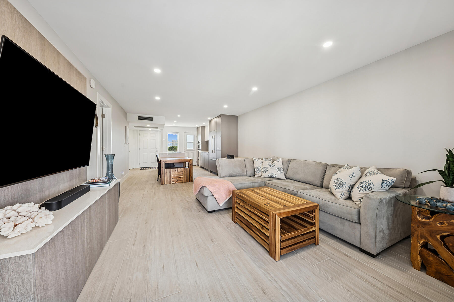 2871 North Ocean Boulevard, Unit M436 Boca Raton, FL 33431 - Photo 10 of 20 a living room with furniture and a flat screen tv