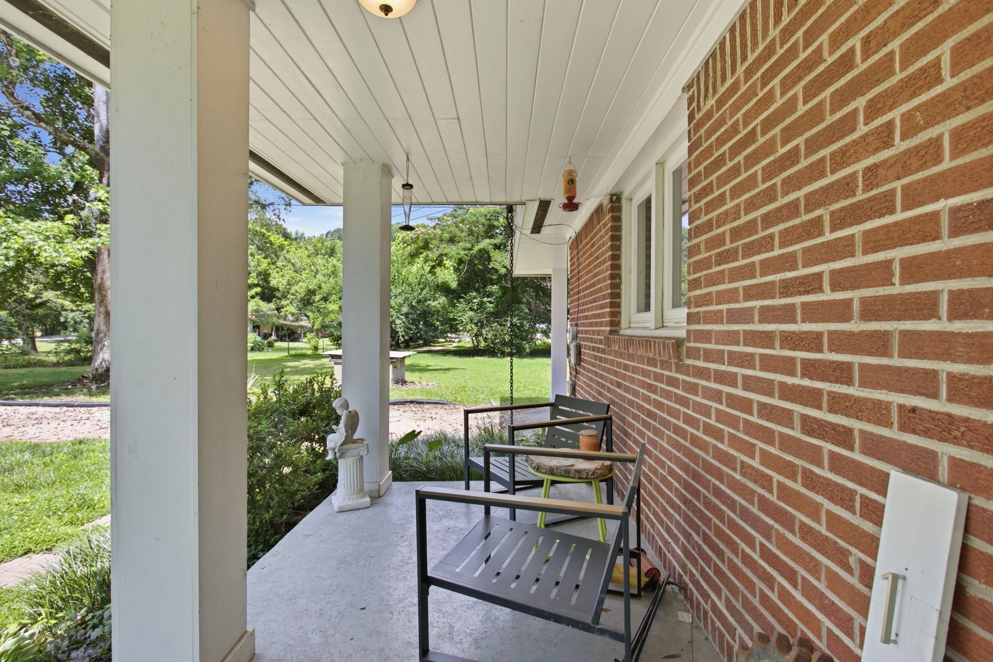 150 Toms Creek Road Linden, TN 37096 - Photo 17 of 23 a view of a patio with table and chairs and potted plants