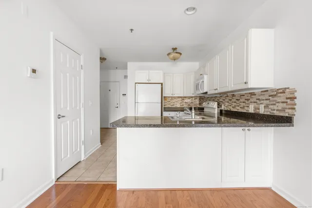a kitchen with stainless steel appliances granite countertop a sink and cabinets
