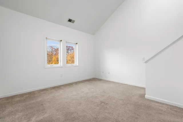 a view of an empty room with stairs