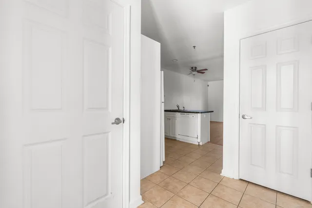 a view of a kitchen with a white cabinet and a refrigerator