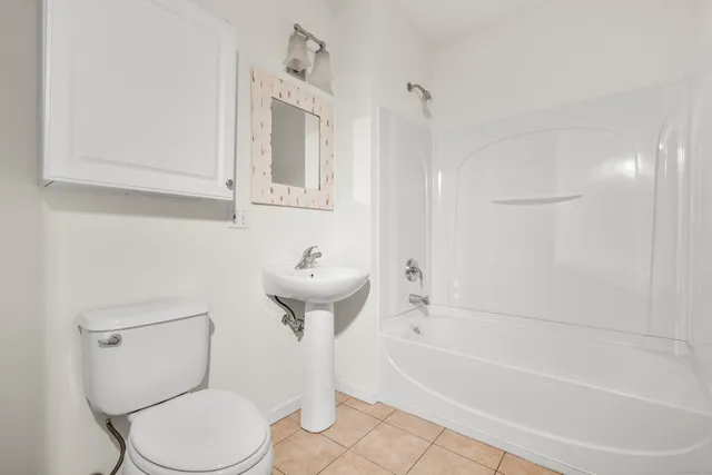 a bathroom with a sink a toilet and bathtub