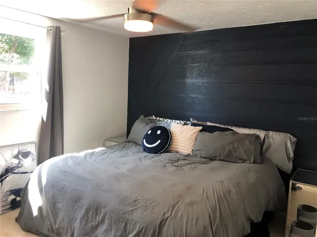 a bedroom with a bed and a window