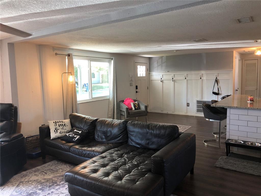 6425 Reno Avenue New Port Richey, FL 34653 - Photo 7 of 17 a living room with furniture and a fireplace