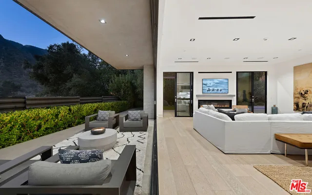 a living room with furniture and a floor to ceiling window