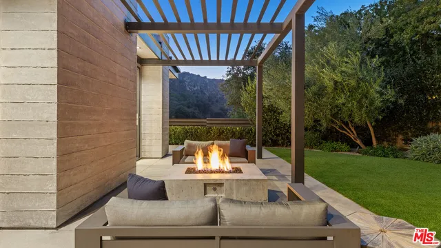 a view of a couches in the patio with a fire pit