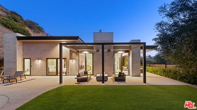 a view of a house with backyard porch and garden