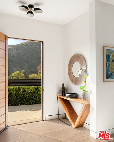 a living room with a rug and a painting on the wall
