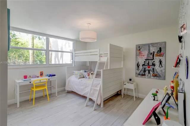 a bedroom with furniture and a wooden floor