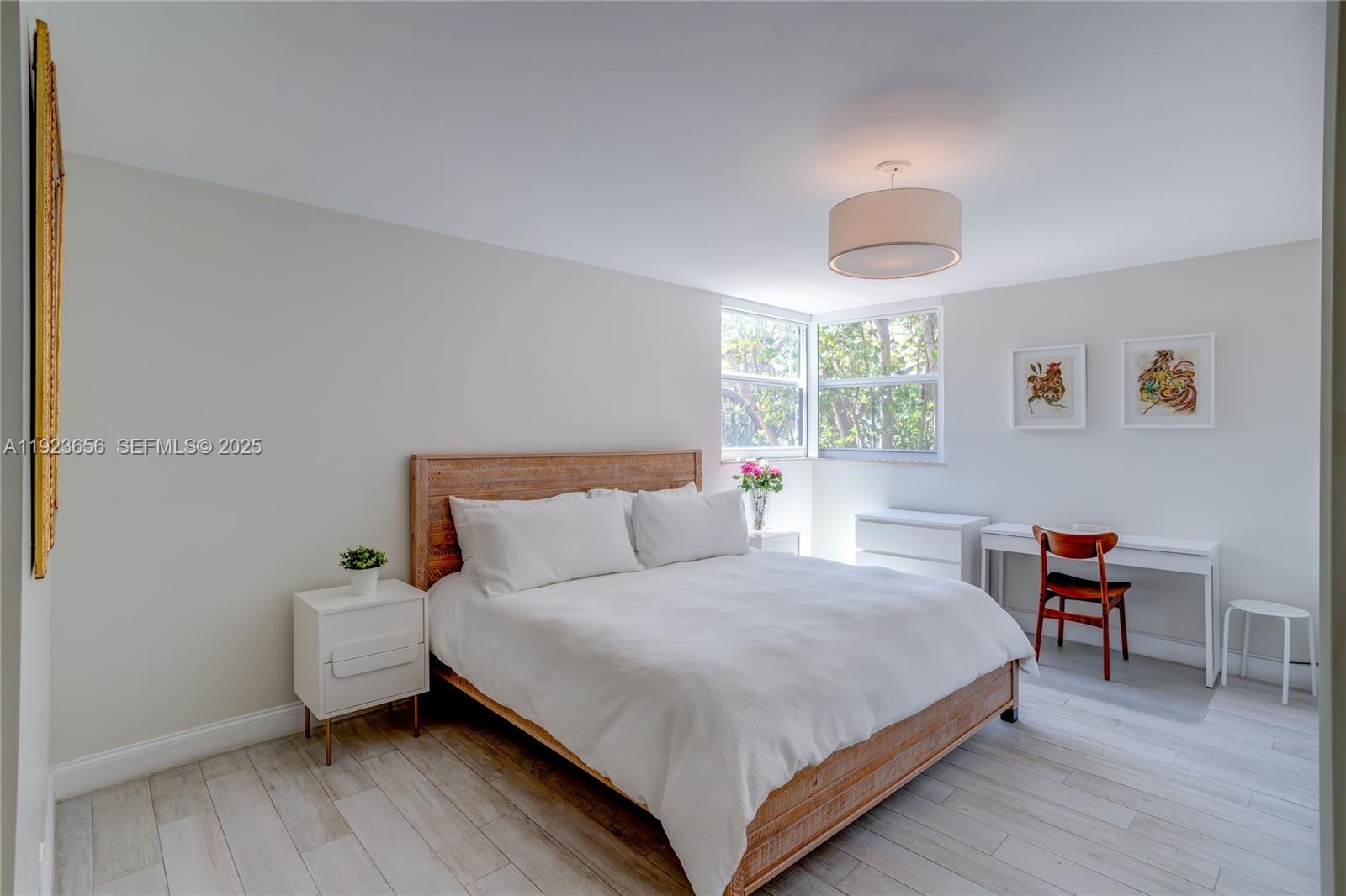 55 Ocean Ln Drive, Unit 2033 Key Biscayne, FL 33149 - Photo 15 of 21 a bedroom with a bed and a table