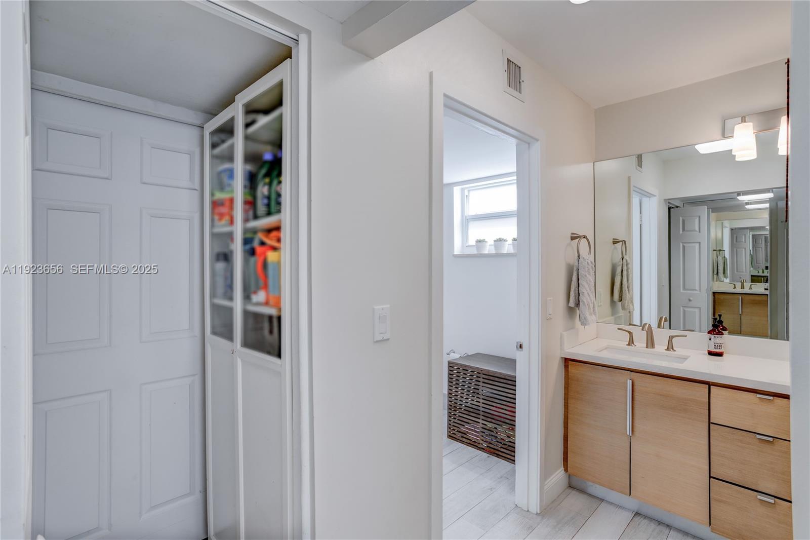 55 Ocean Ln Drive, Unit 2033 Key Biscayne, FL 33149 - Photo 18 of 21 a bathroom with a shower sink and mirror