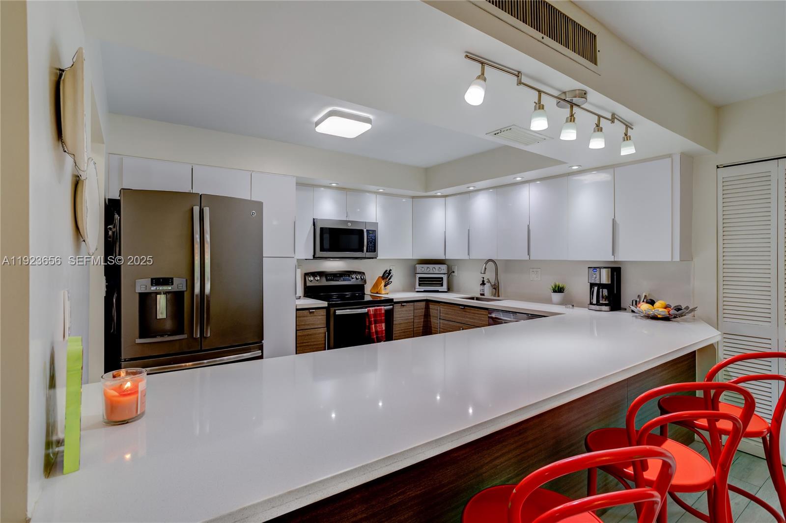 55 Ocean Ln Drive, Unit 2033 Key Biscayne, FL 33149 - Photo 8 of 21 a kitchen with stainless steel appliances a refrigerator sink and stove