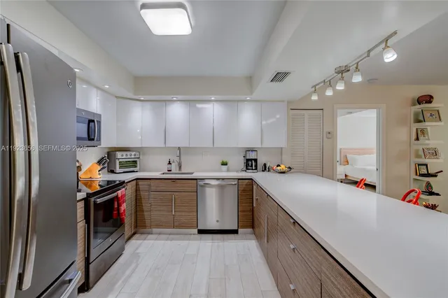 a kitchen with a sink cabinets and stainless steel appliances