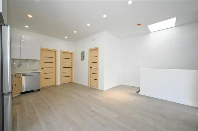 a view of a kitchen with refrigerator and stove