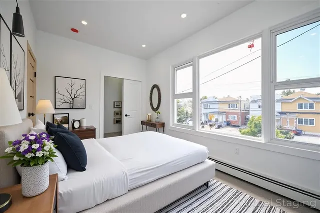 a bedroom with a large bed and a large window