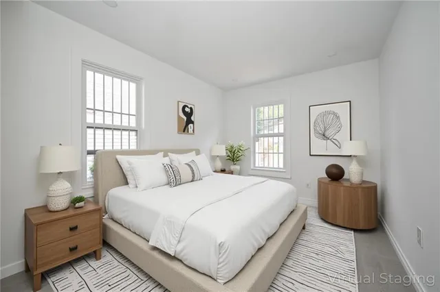 a bedroom with bed and window