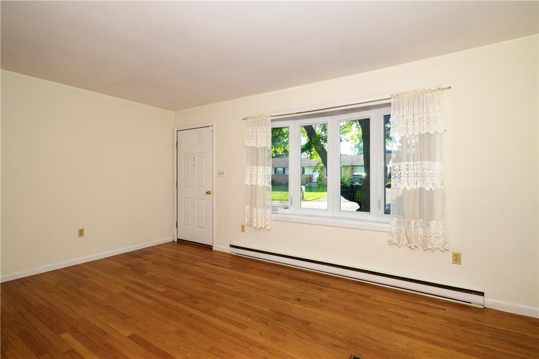 1644 9th Street Bethlehem, PA 18020 - Photo 3 of 27 Hardwood flooring extends throughout this well-lit living area, featuring a large window overlooking the neighborhood.