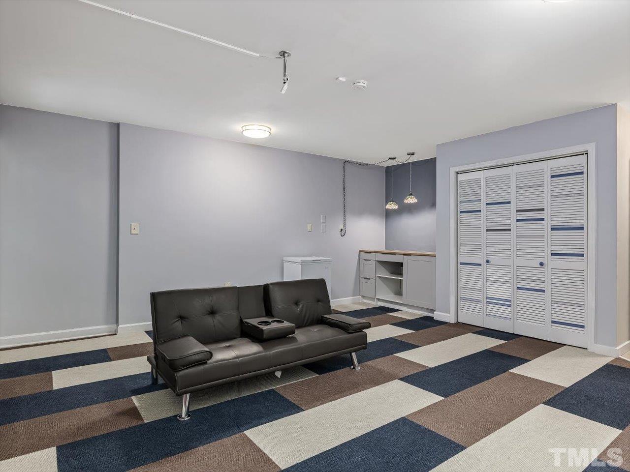 115 Inverness Court Cary, NC 27511 - Photo 13 of 25 a living room with furniture and a rug