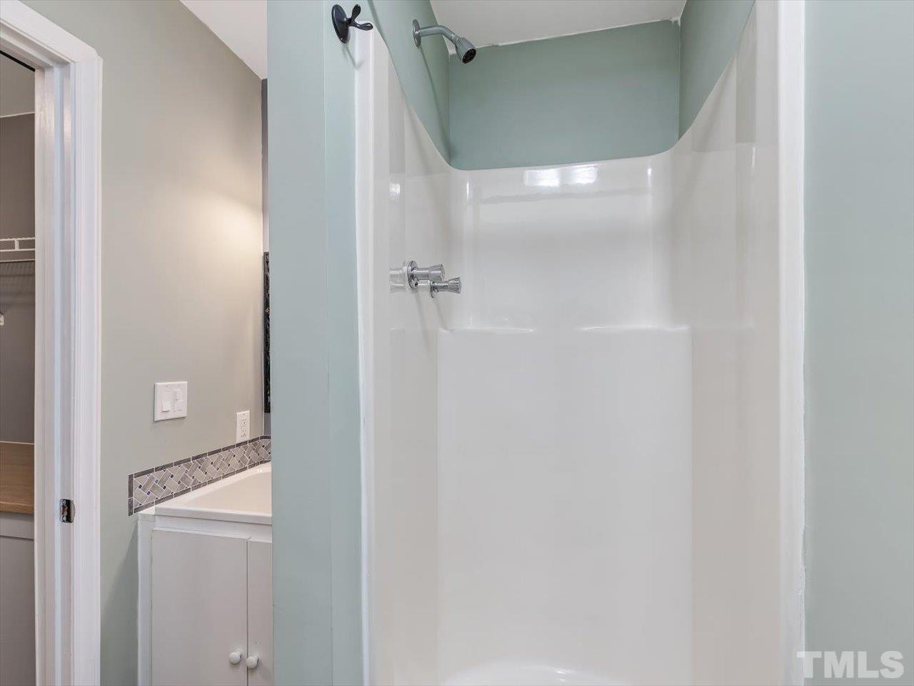 115 Inverness Court Cary, NC 27511 - Photo 17 of 25 a bathroom with a glass shower door