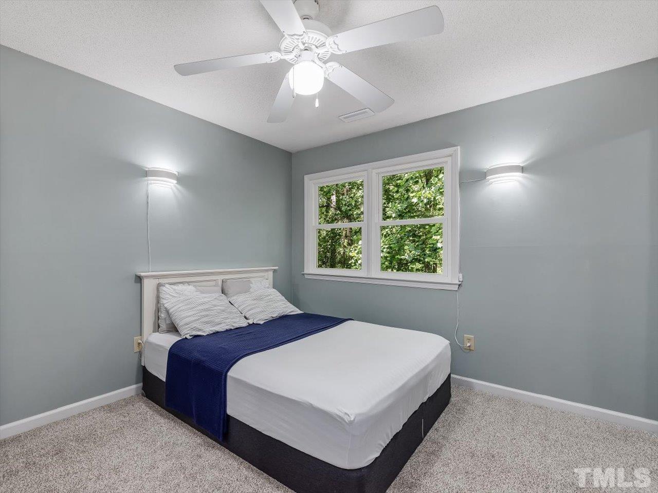 115 Inverness Court Cary, NC 27511 - Photo 19 of 25 a bedroom with a bed and a window