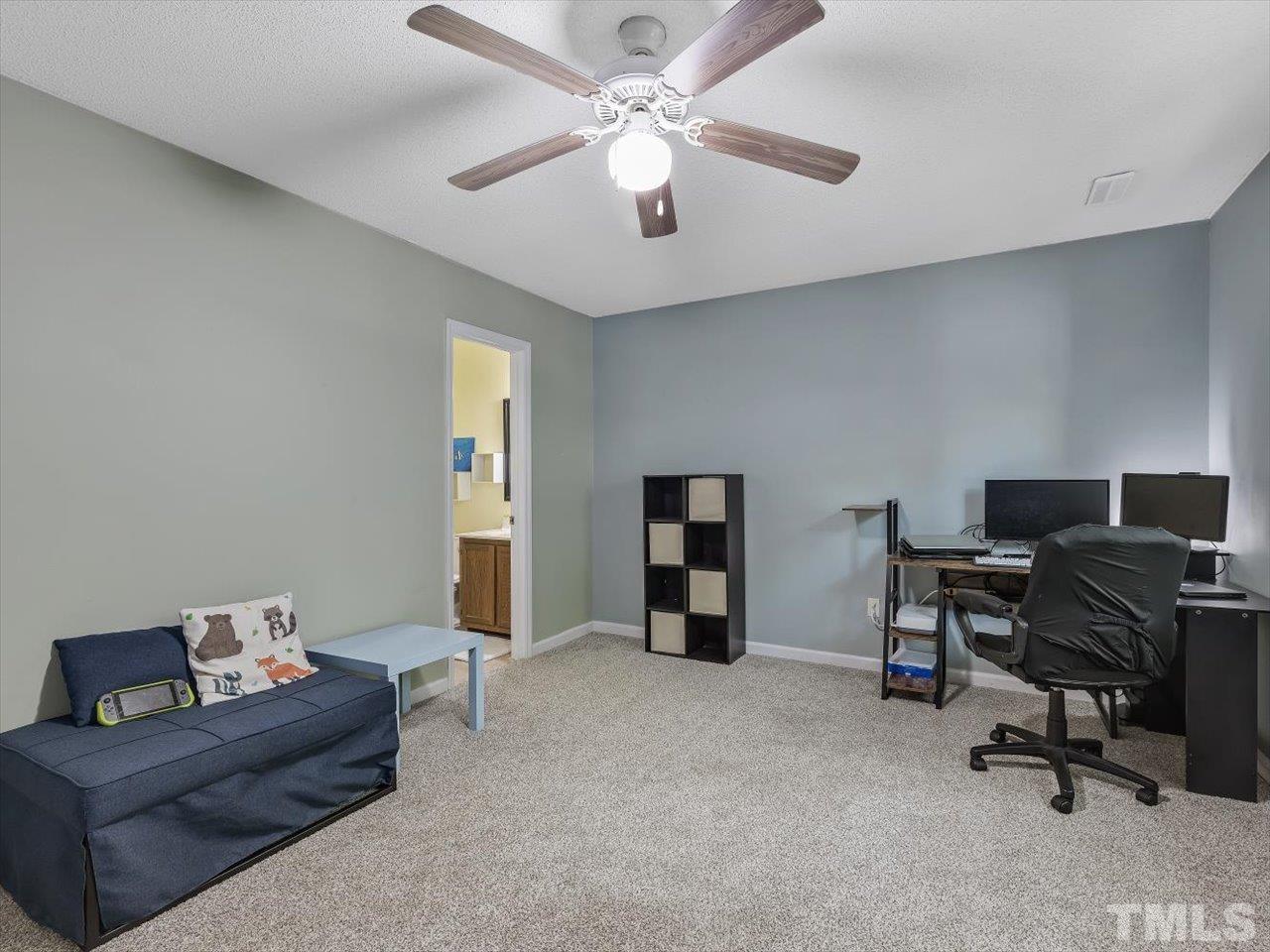 115 Inverness Court Cary, NC 27511 - Photo 21 of 25 a livingroom with workspace and a couch