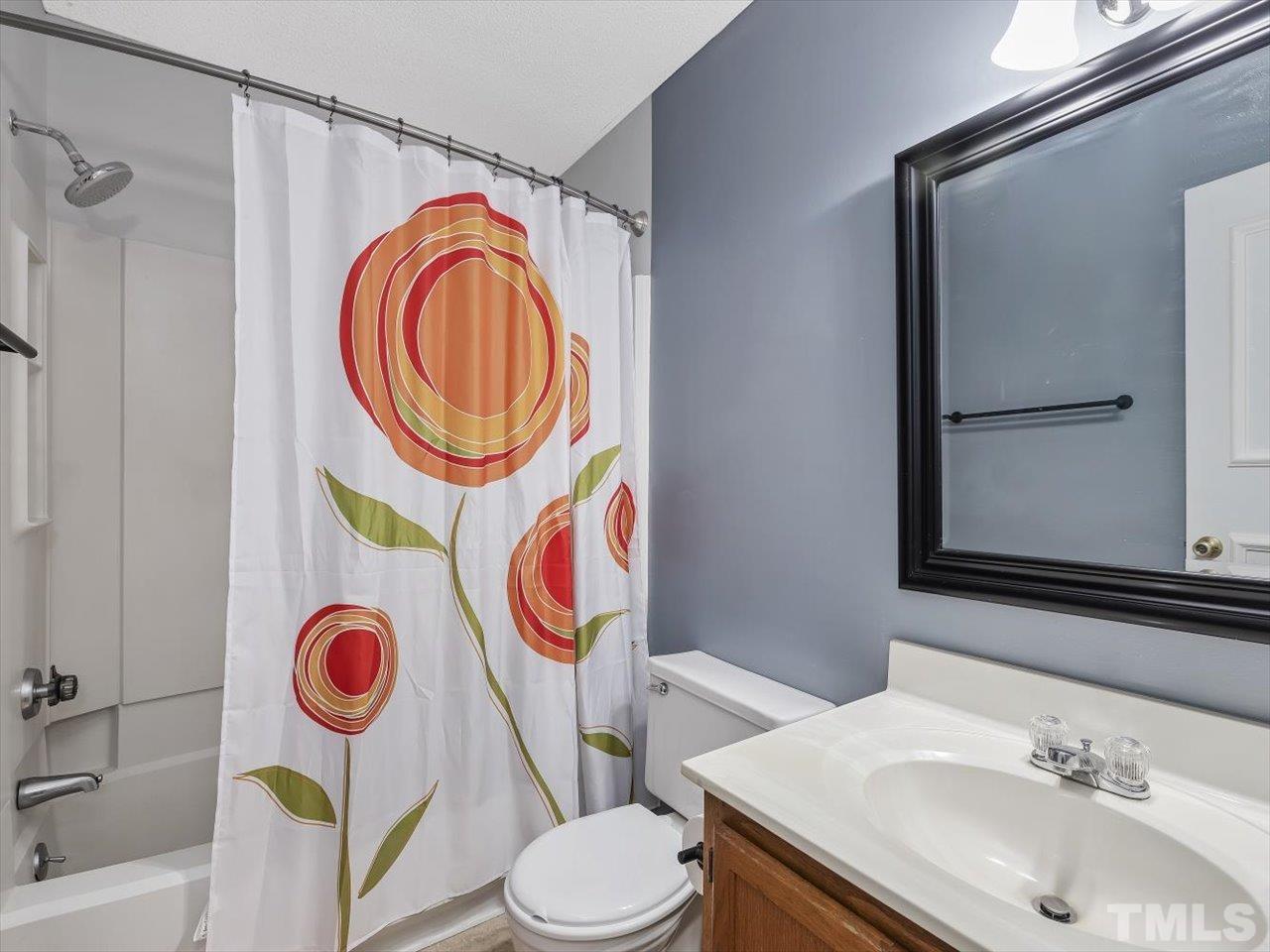 115 Inverness Court Cary, NC 27511 - Photo 23 of 25 a bathroom with a sink a toilet and a mirror