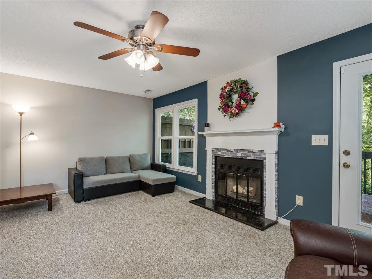 115 Inverness Court Cary, NC 27511 - Photo 5 of 25 a living room with furniture and a fireplace