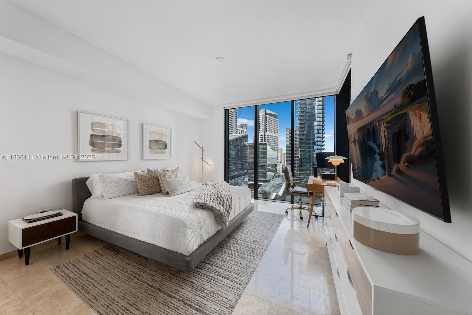 88 Southwest 7th Street, Unit 1401 Miami, FL 33130 - Photo 12 of 35 a bedroom with a large bed a flat tv screen and a couch