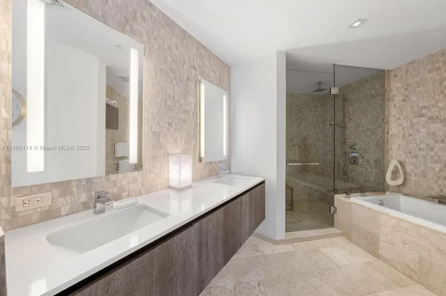 a bathroom with a granite countertop tub sink and mirror