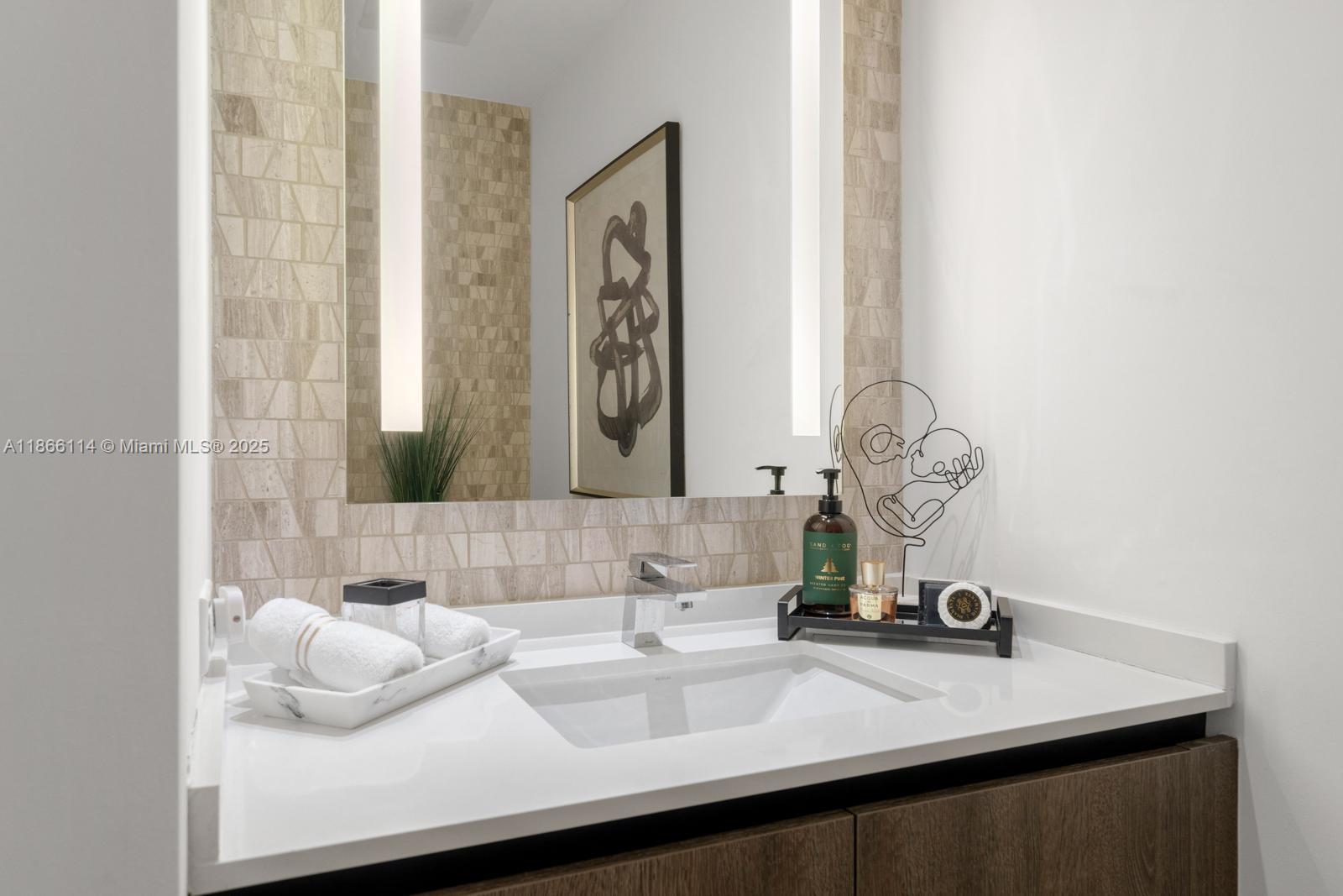 88 Southwest 7th Street, Unit 1401 Miami, FL 33130 - Photo 21 of 35 a bathroom with a sink and a mirror