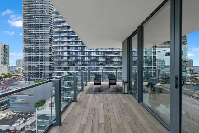 a view of a balcony with a dining table and chairs