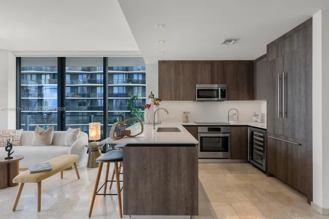 a kitchen with a refrigerator and a stove top oven