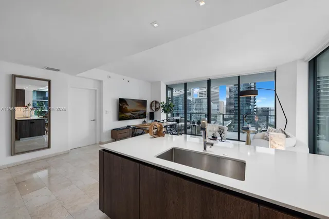a kitchen with sink a counter and cabinets