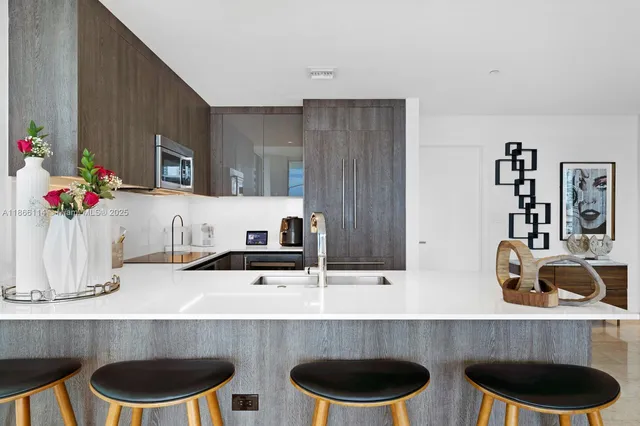 a kitchen with a microwave a stove and cabinets